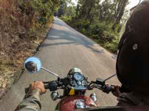 A person riding a motorcycle on a curved road, emphasizing the importance of motorcycle accident prevention and safety measures