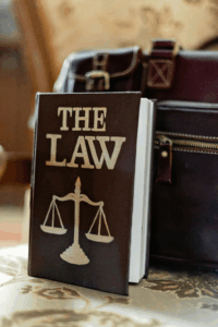 The Law Book tilted on a briefcase, that explains the importance of Accident Reconstruction Experts