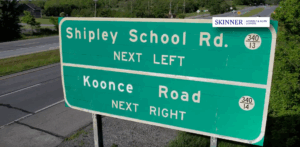 Highway sign for Shipley School Road and Koonce Road, highlighting one of the most dangerous intersections known for traffic accidents and confusion for drivers.